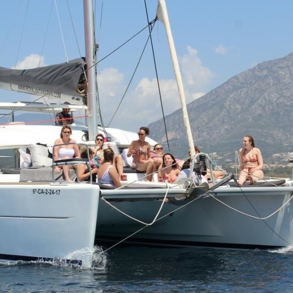 a group of people in a small boat in a body of water