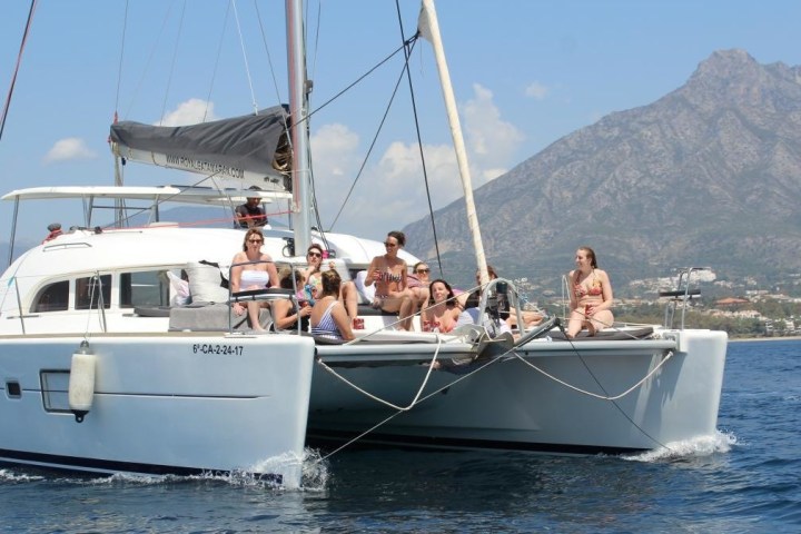 a group of people in a small boat in a body of water