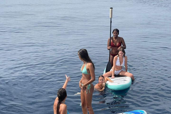 a group of people in a boat on a body of water
