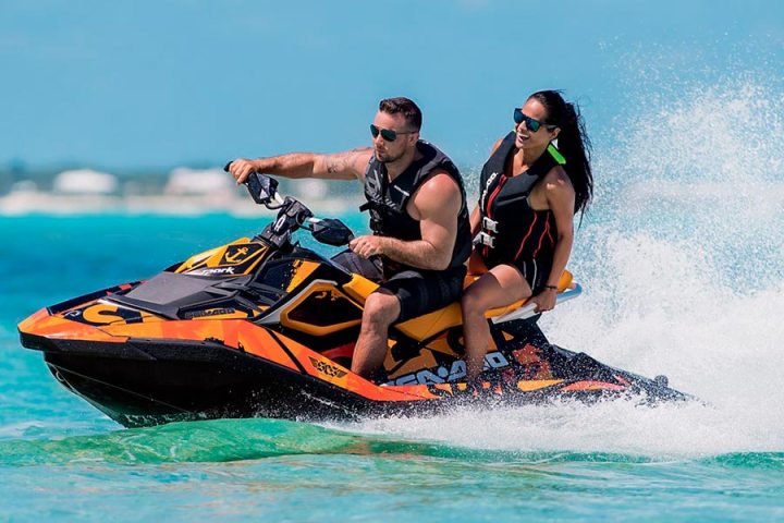 a person riding on the back of a boat in the water