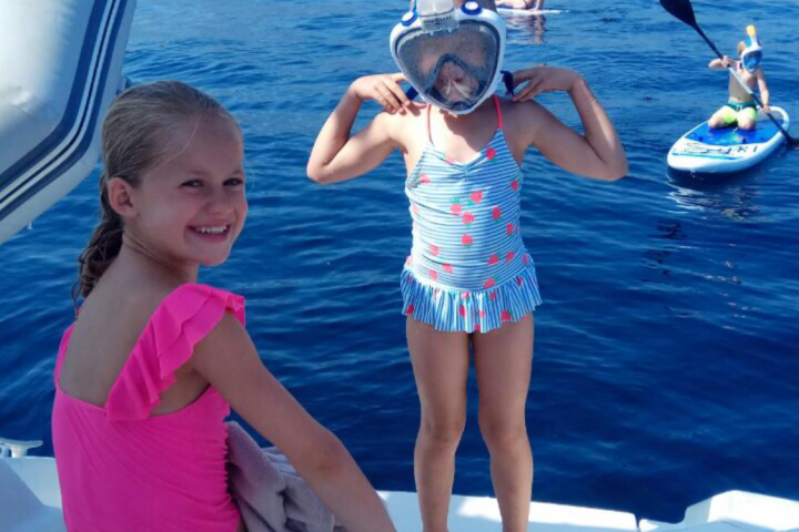 a group of people standing next to a body of water