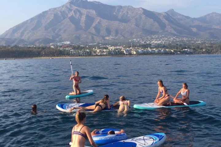 a group of people in a small boat in a body of water