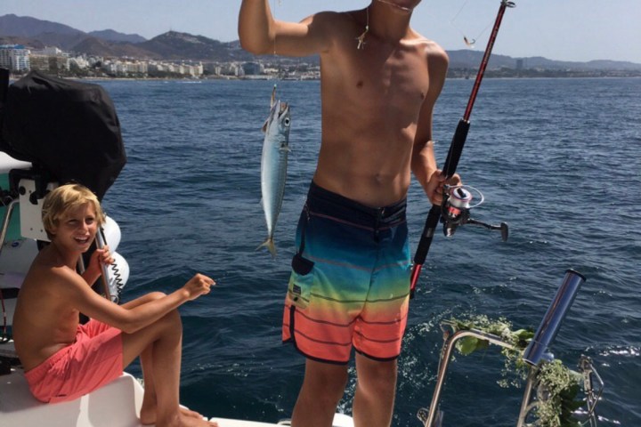 a man and a woman standing next to a body of water
