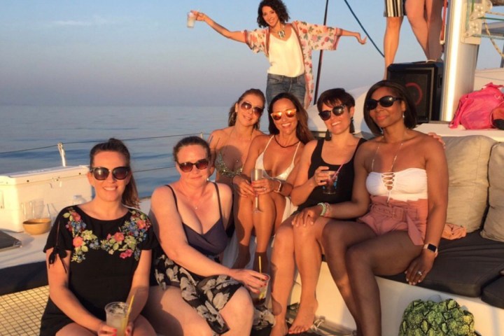 a group of people on a boat posing for the camera