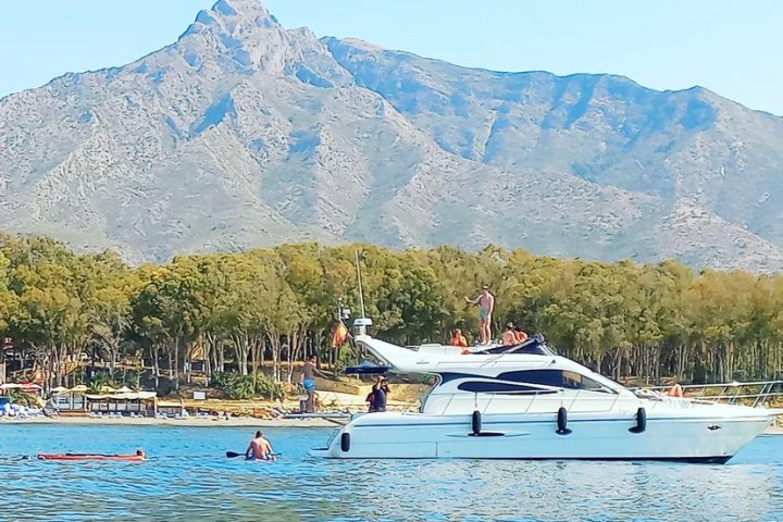 a group of people in a boat on a body of water