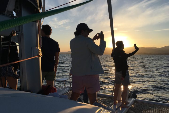 a group of people standing around in the ocean