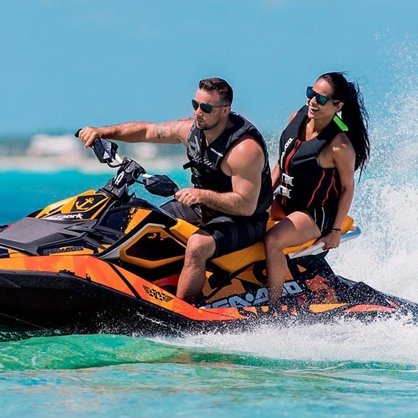 a person riding on the back of a boat in the water