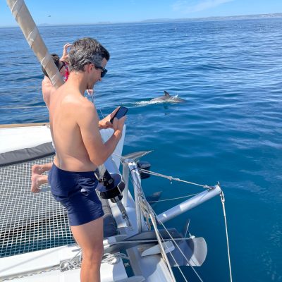 a woman standing next to a body of water