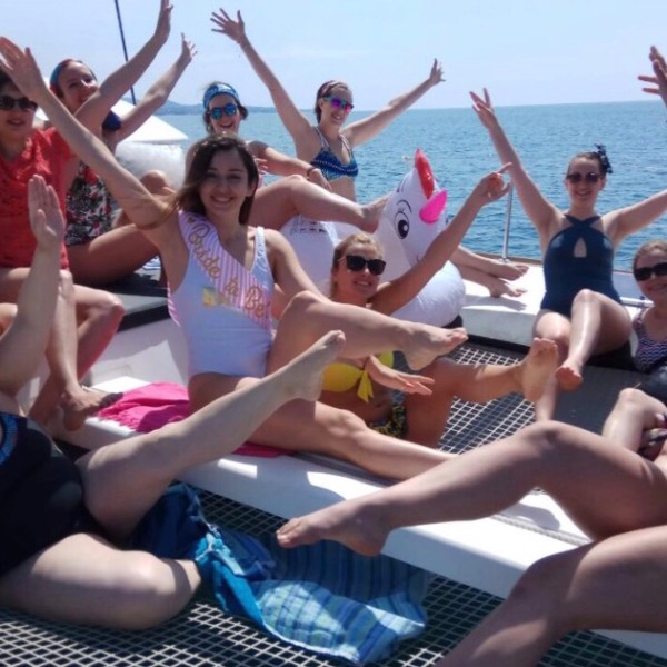 a group of people sitting next to a body of water