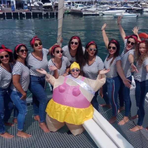 a group of people posing in front of a body of water