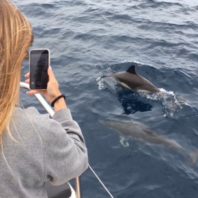 a woman standing next to a body of water