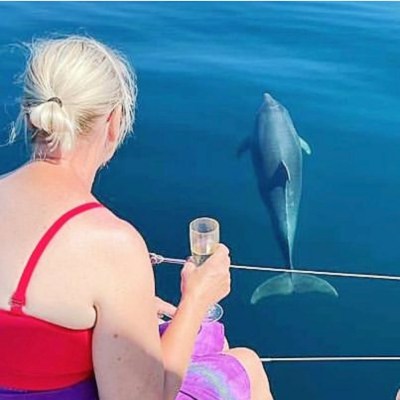 a woman sitting on a boat in the water
