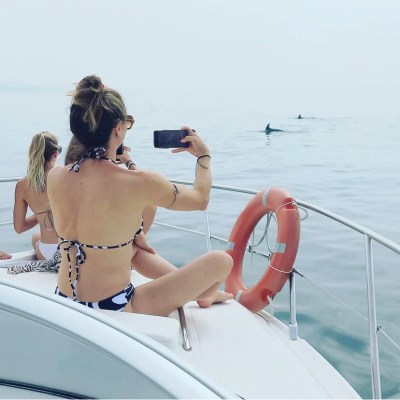 a woman standing next to a body of water