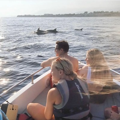 a woman sitting on a boat in the water