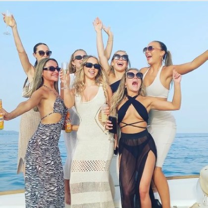 a group of people on a beach posing for the camera