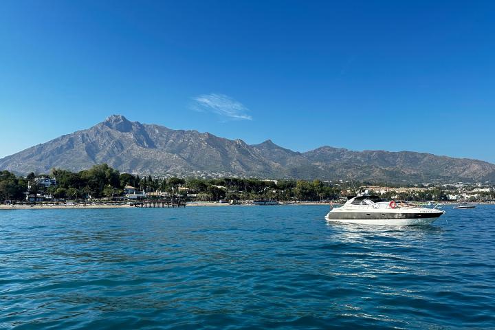a large body of water with a mountain in the background