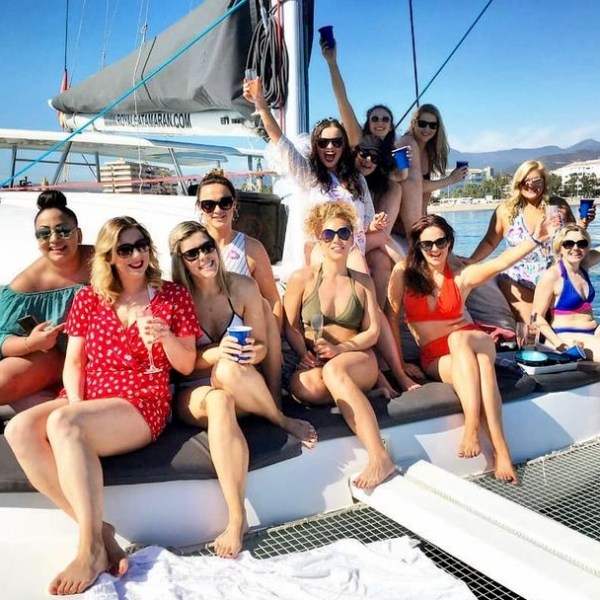 a group of people sitting in a boat on a body of water