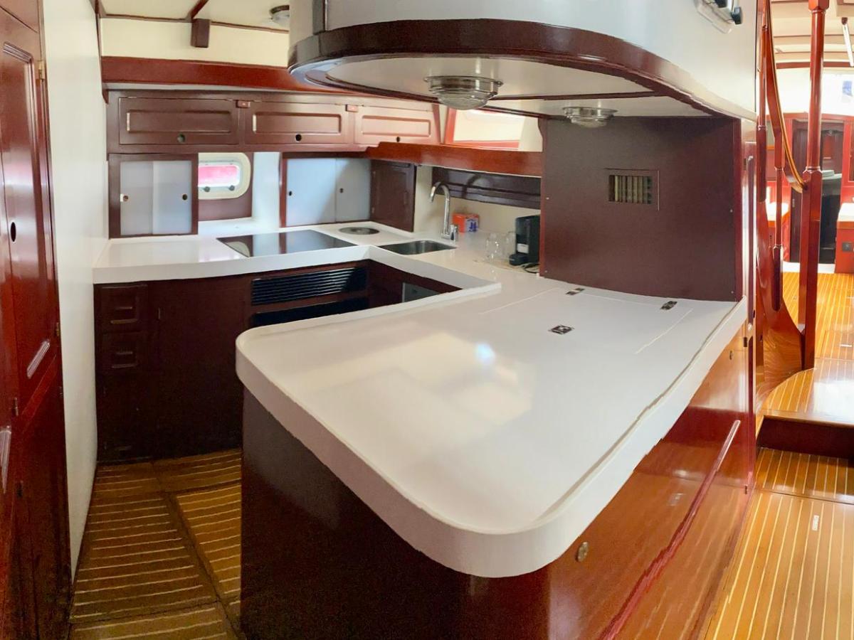 a kitchen with a sink and a chair in a room