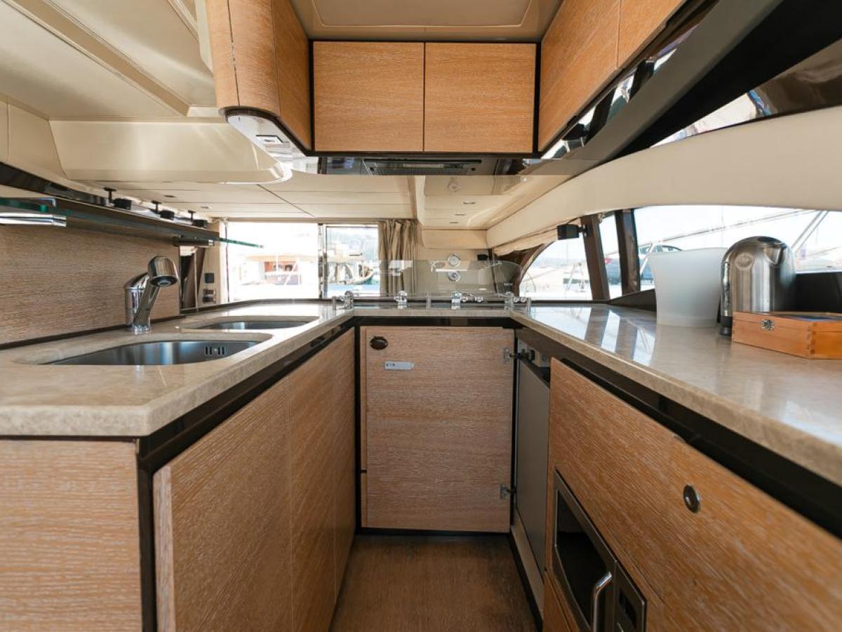 a modern kitchen with stainless steel appliances and wooden cabinets