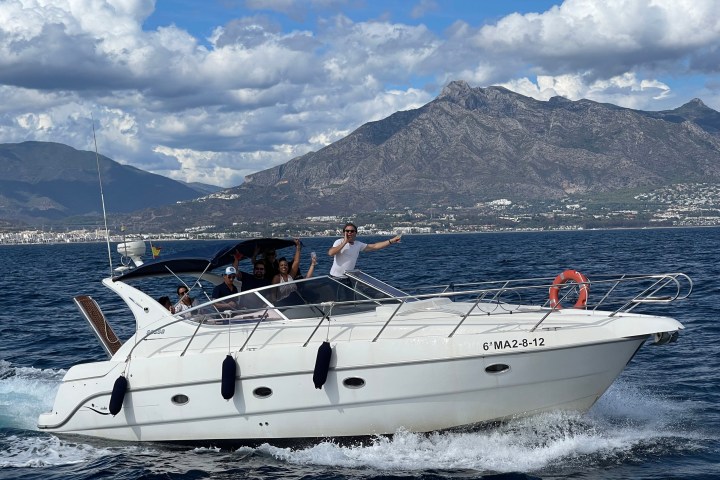 a boat on a body of water with a mountain in the background