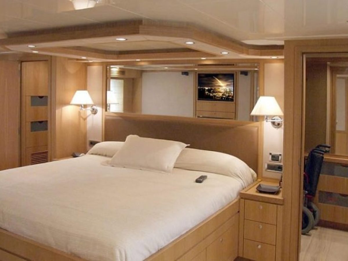 a bedroom with a bed and desk in a room