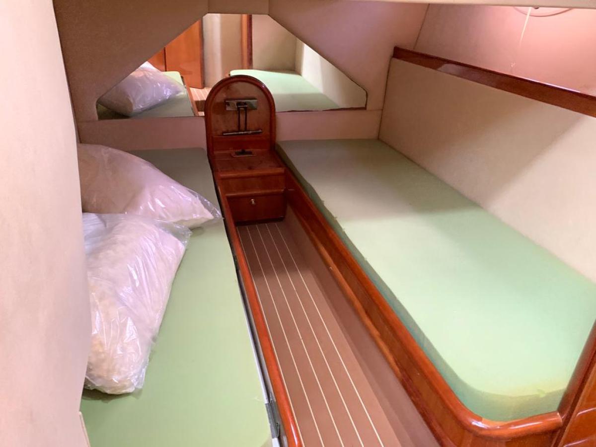 a bedroom with a bed and a chair in a room