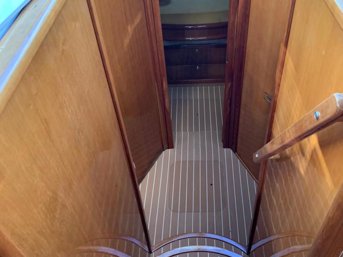 a chair sitting in front of a wooden cabinet