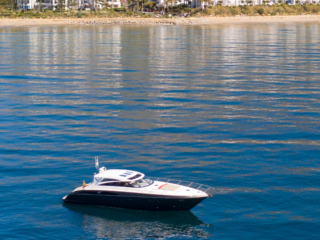 a small boat in a body of water with a mountain in the background