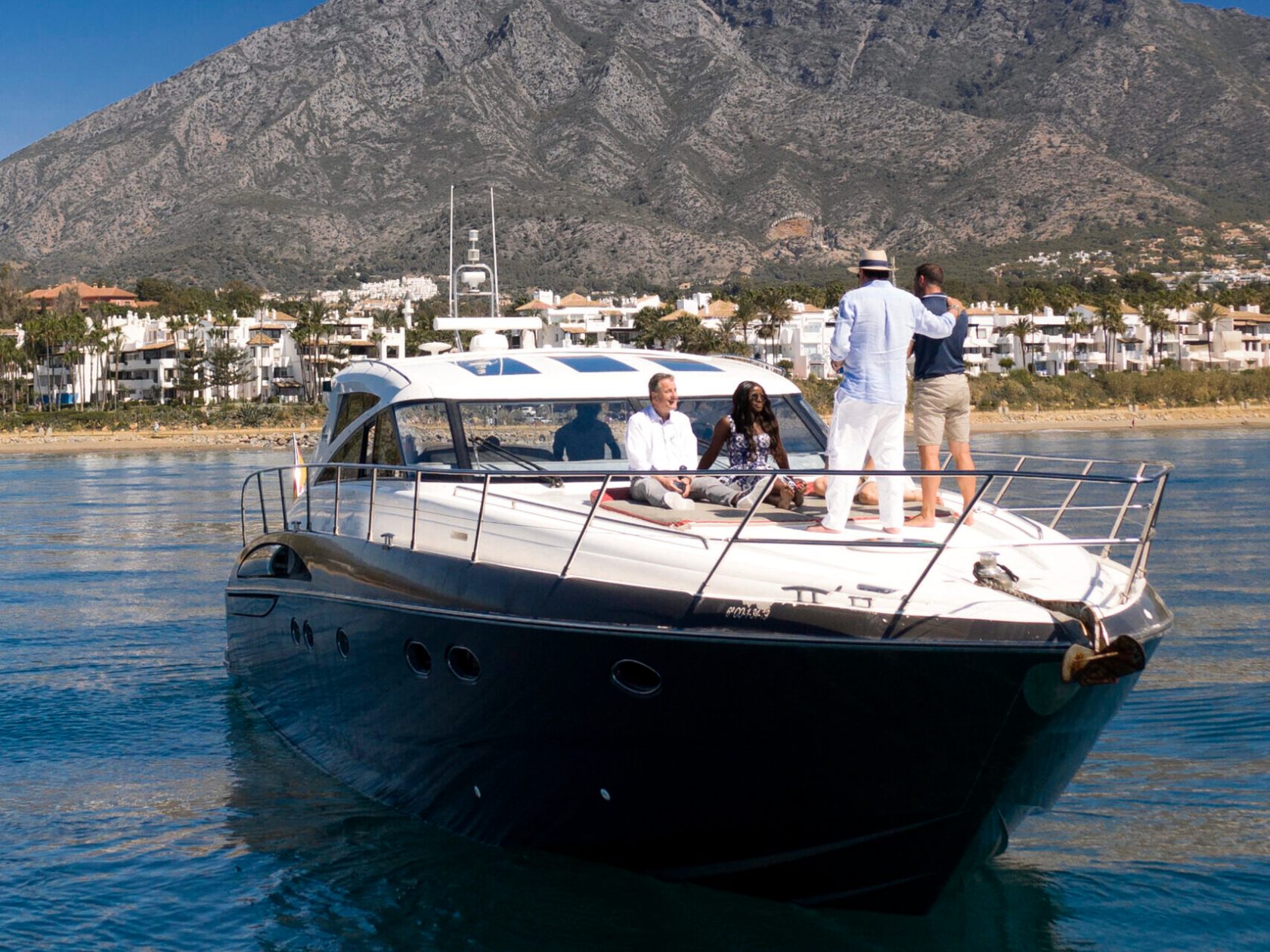 a small boat in a body of water with a mountain in the background