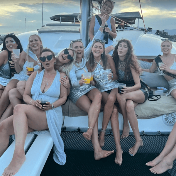 a group of people sitting on a boat posing for the camera
