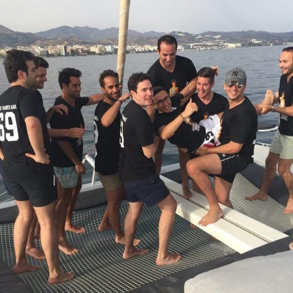 a group of people on a beach posing for the camera