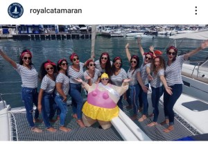 a group of people posing in front of a body of water