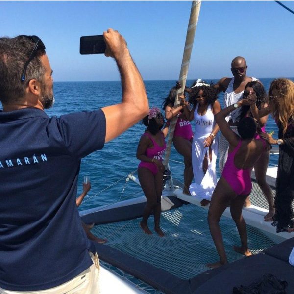 a group of people standing next to a body of water