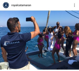 a group of people standing next to a body of water