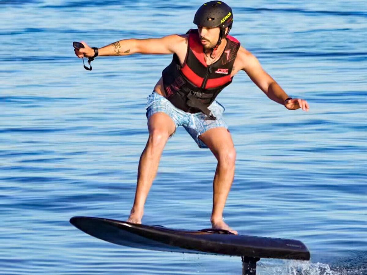 a person riding a board on a body of water