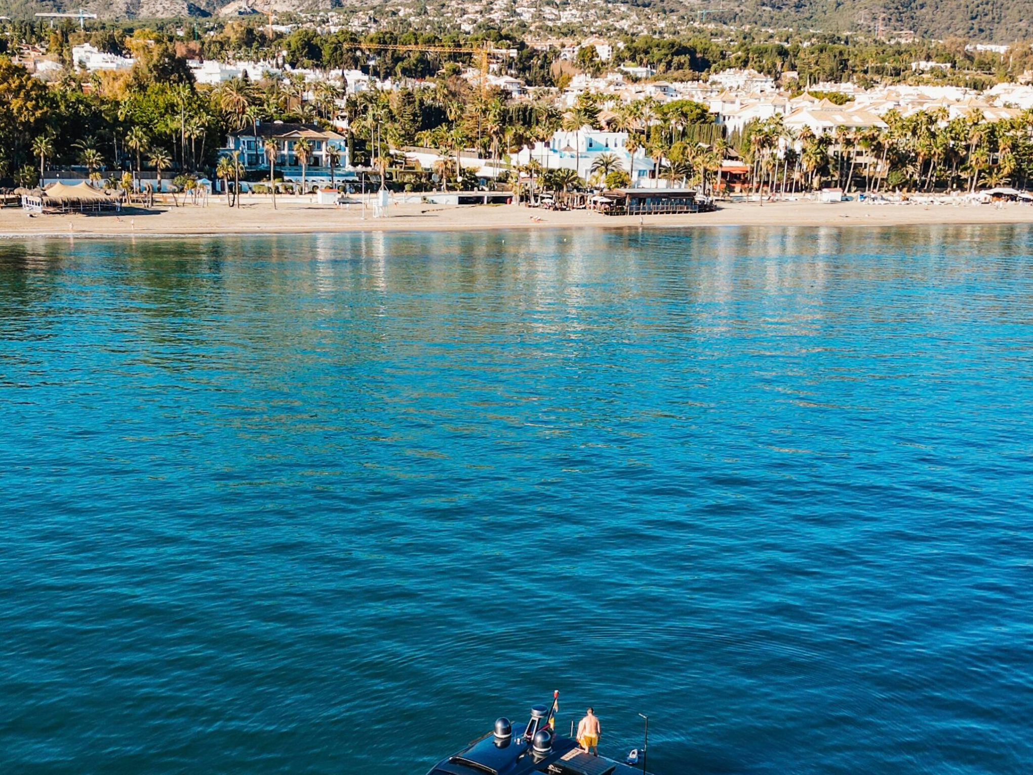 a boat on a body of water with a mountain in the background