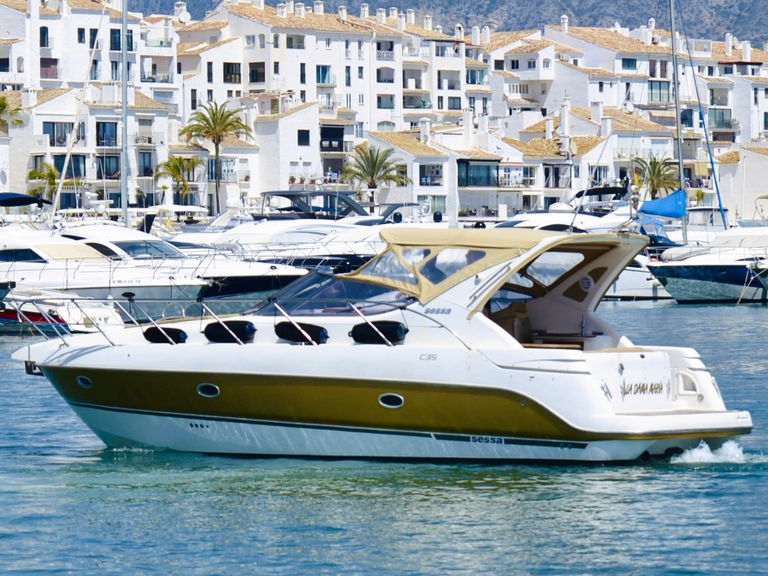 a small boat in a body of water with a city in the background