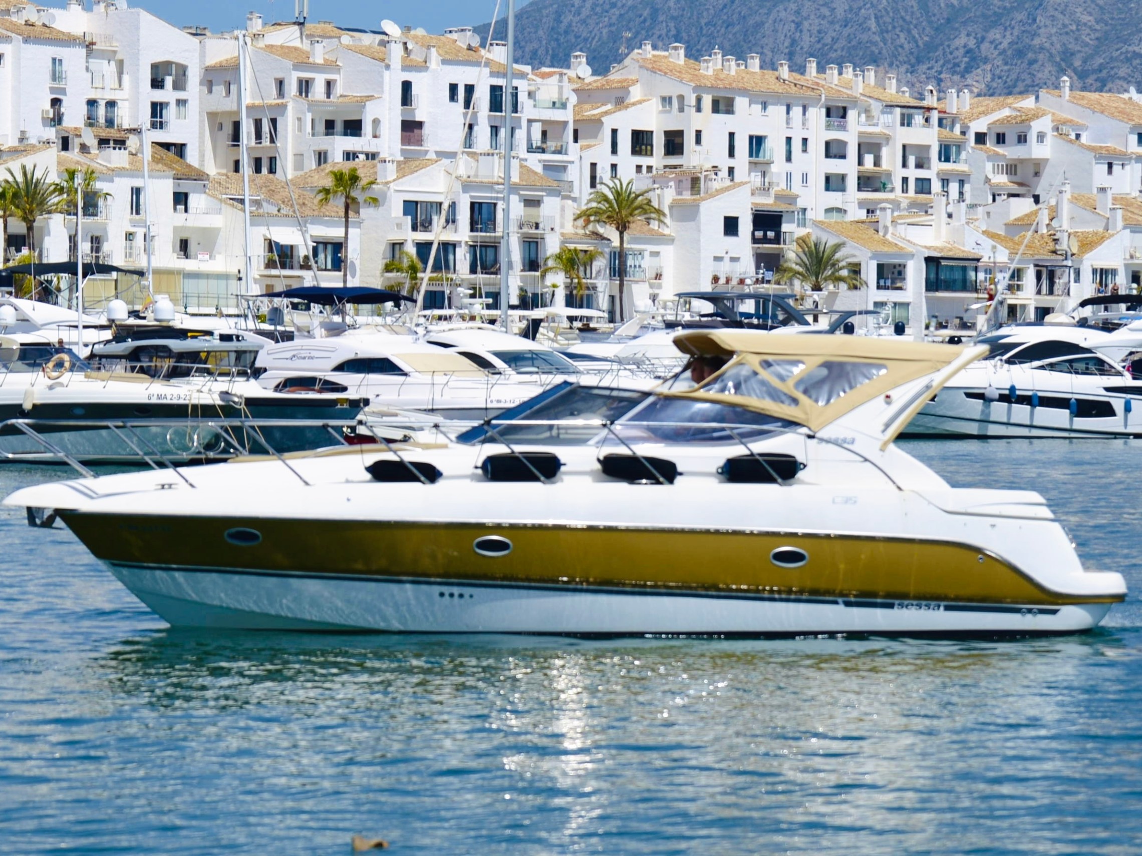 a small boat in a body of water with a city in the background