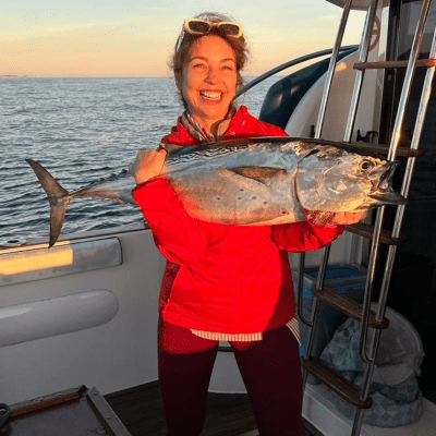 a woman holding a fish in the water