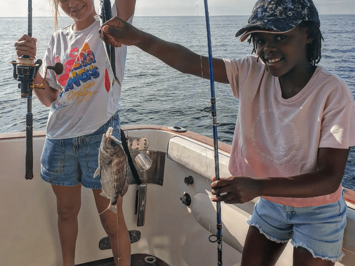 a man and a woman holding a fish