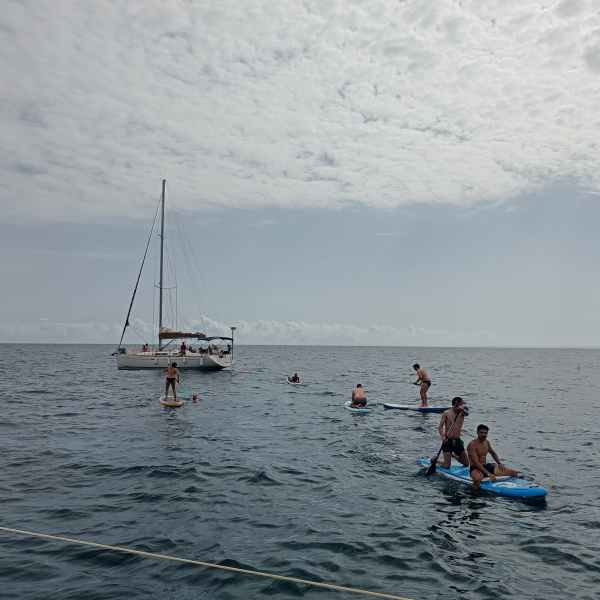 a group of people in a boat on a body of water
