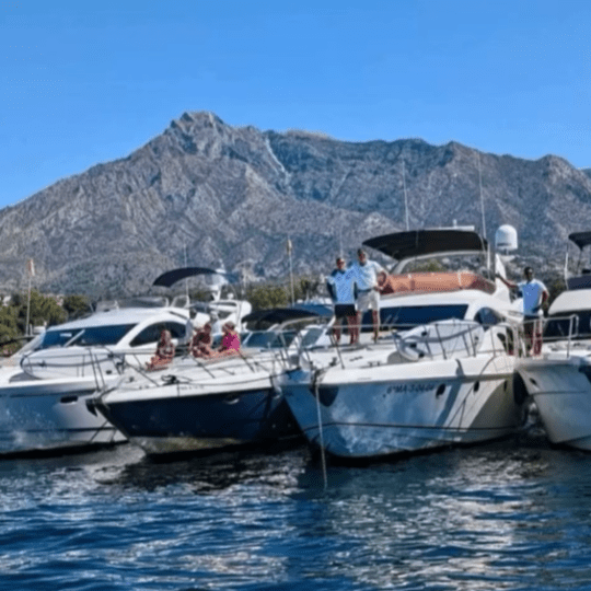 a small boat in a body of water with a mountain in the background