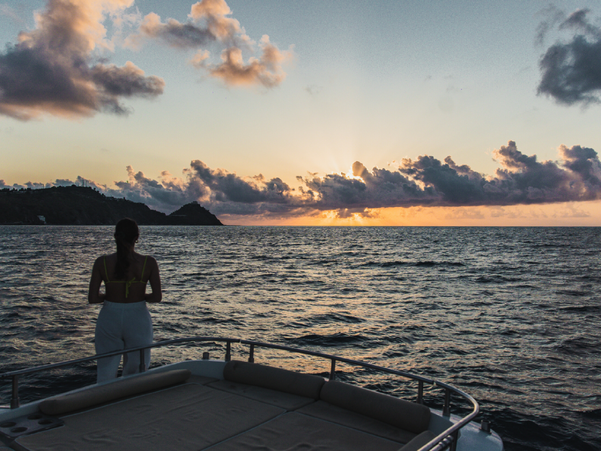 a person standing next to a body of water