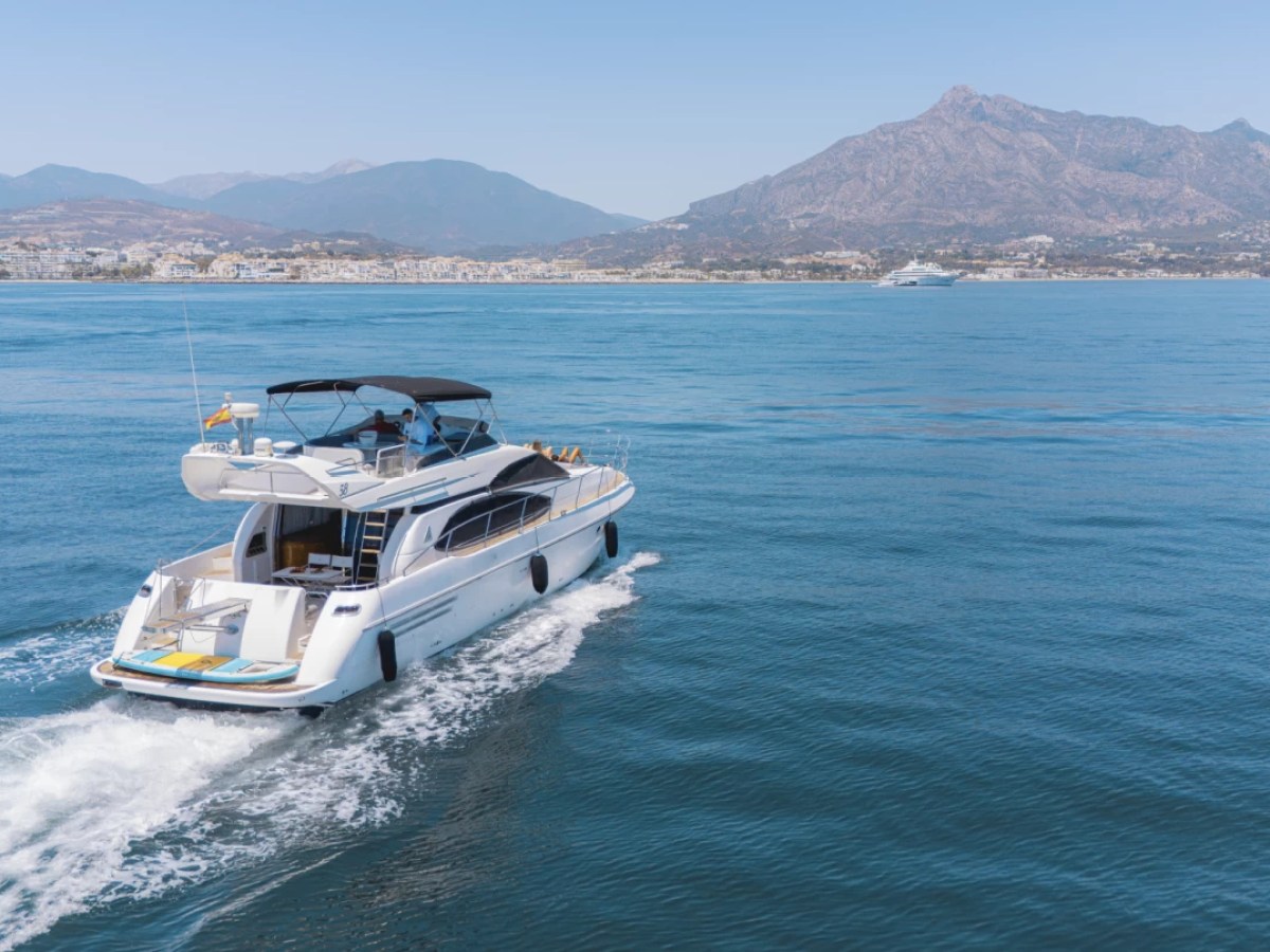 a small boat in a body of water with a mountain in the background