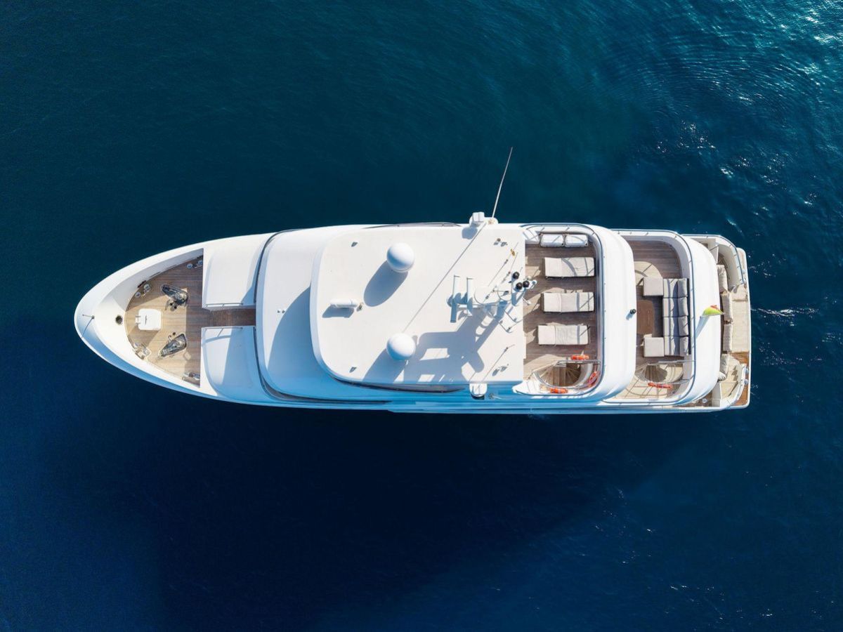 a blue and white boat sitting next to a body of water