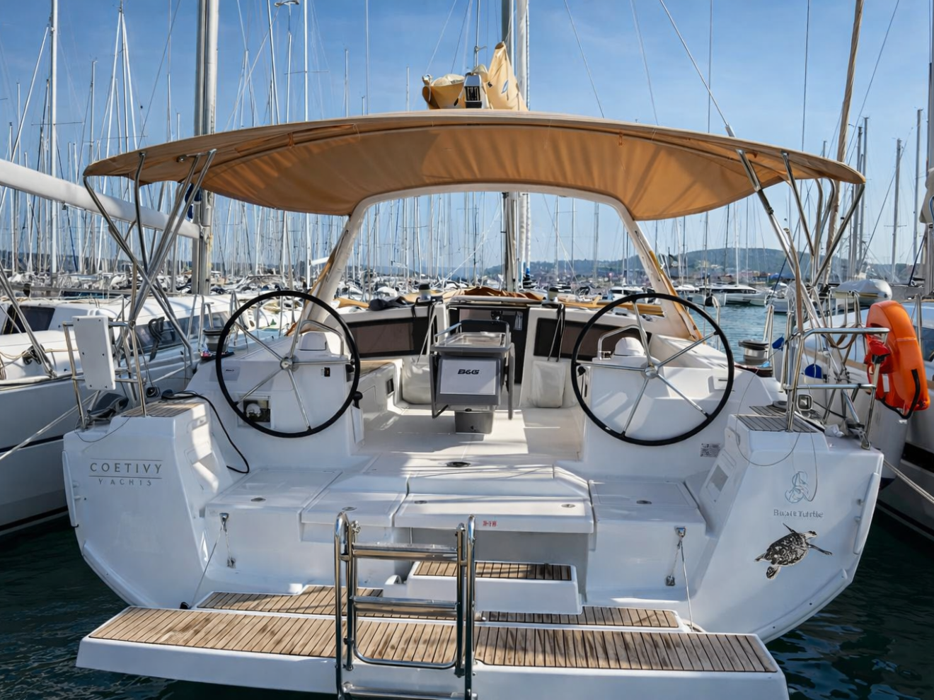 Back view of sailboat with dual steering wheels in a marina.