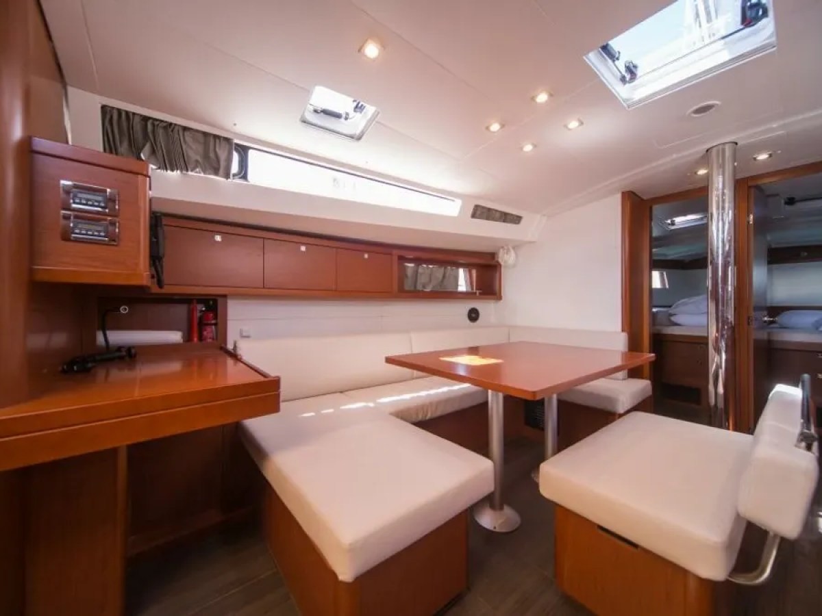 Spacious yacht interior with dining area and skylights.