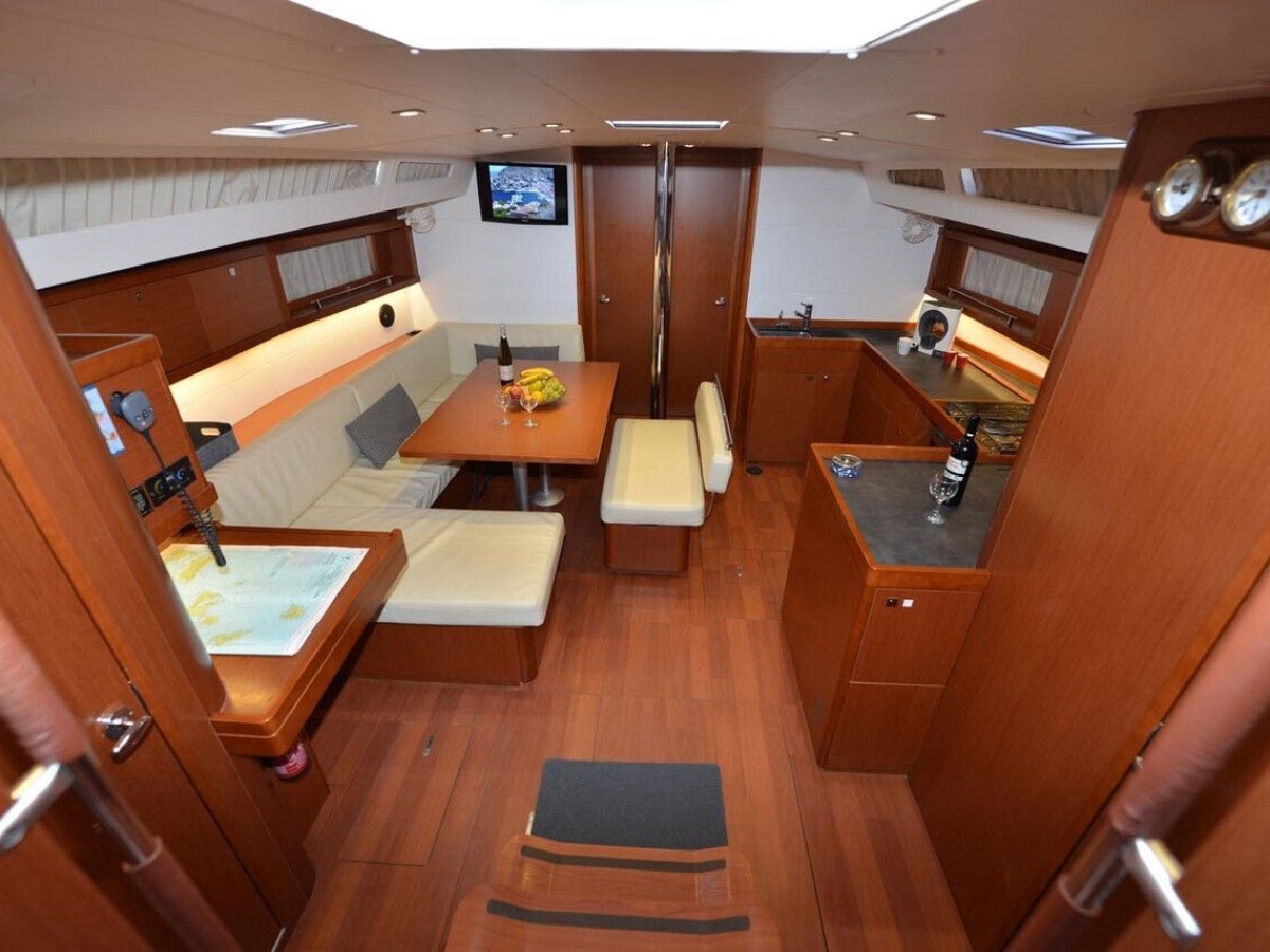 Interior of a yacht with dining area and kitchenette.