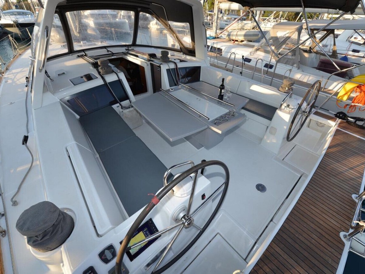 Interior view of a sailboat cockpit with dual steering wheels and spacious seating area.